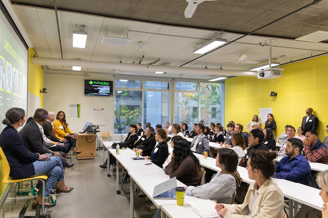 Students in classroom listening to guest speaker