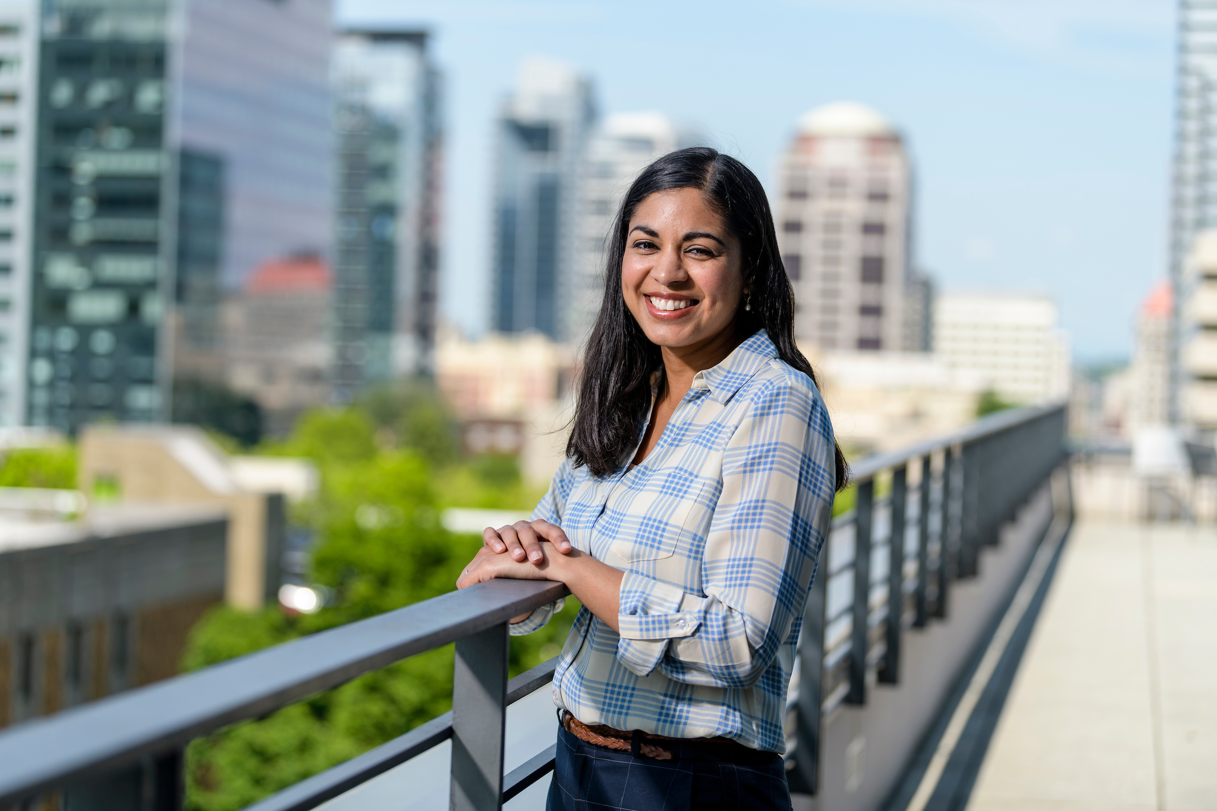 student posing in front of cityscape