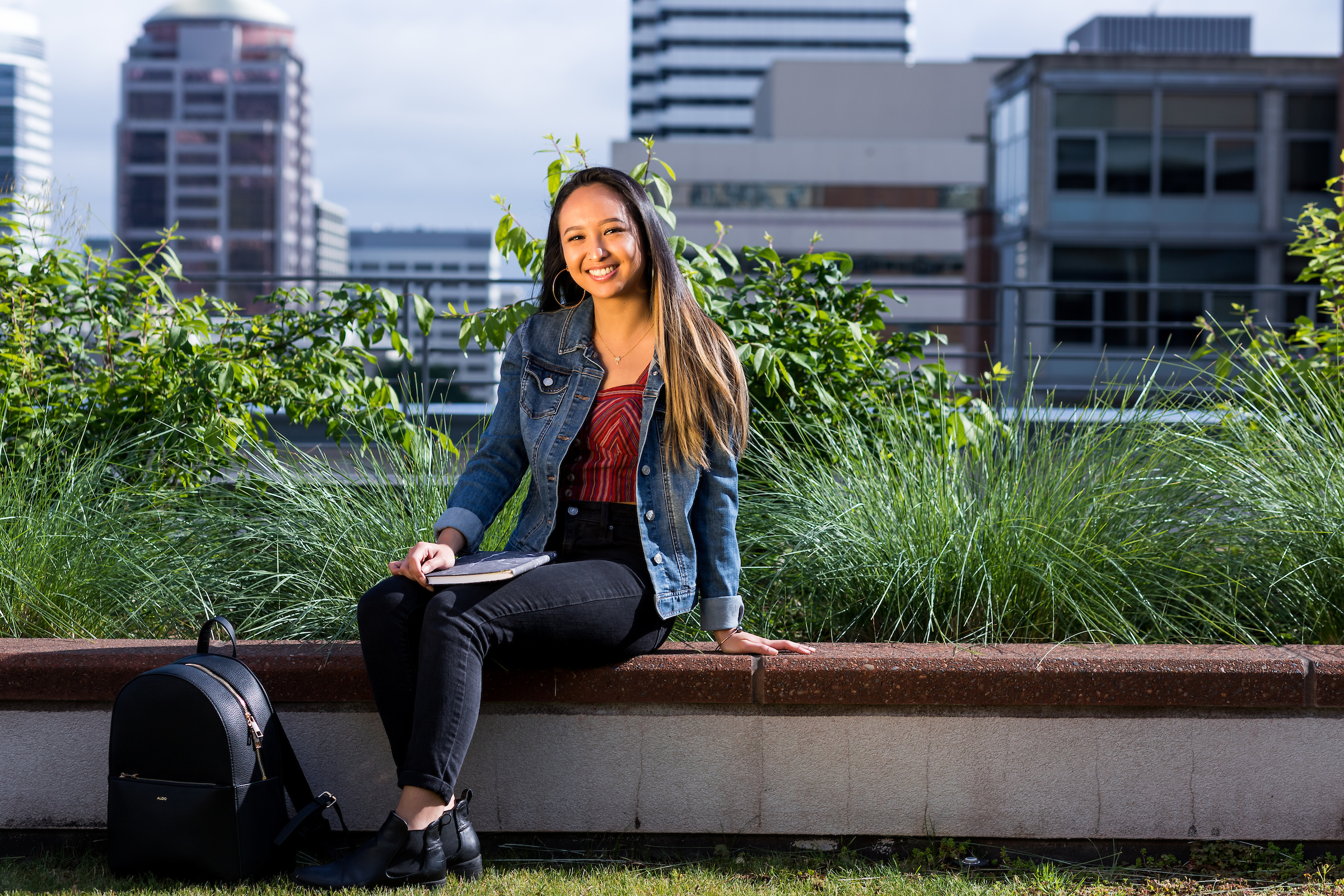 student relaxing with cityscape in the background