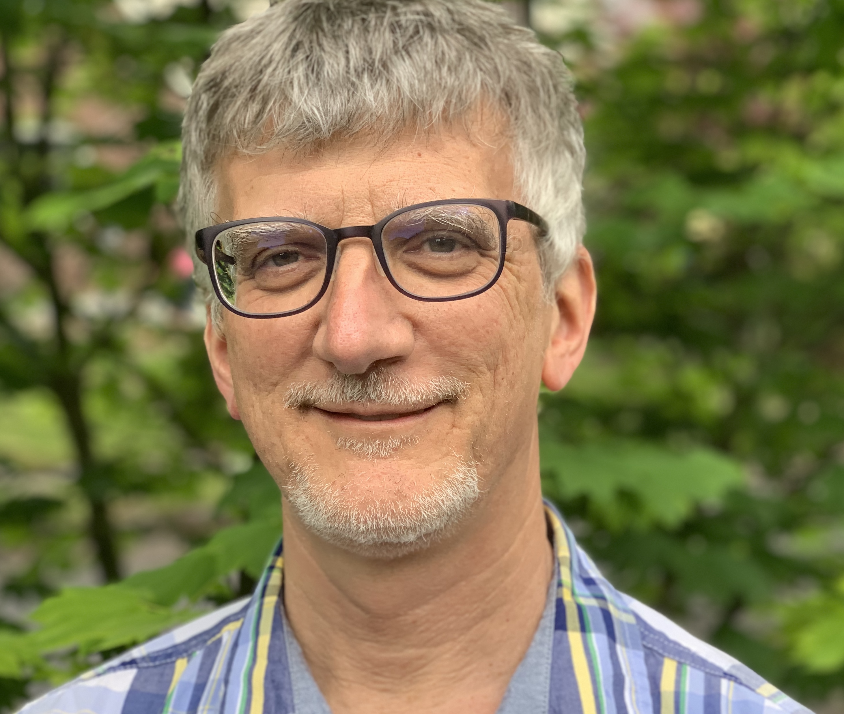 John Perona smiling at camera