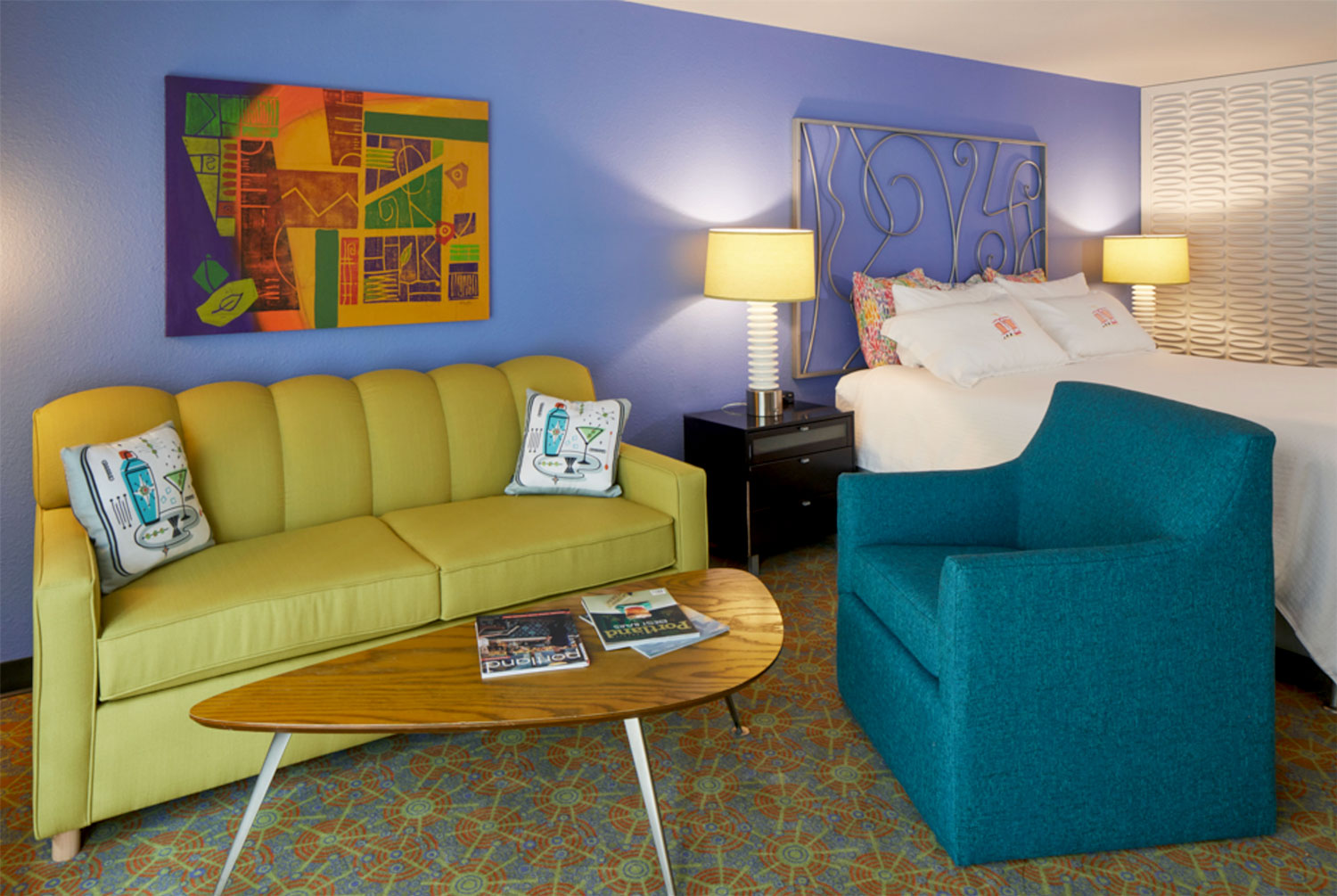 A colorful room at the Inn at Northrup Station features a seating area and bed.