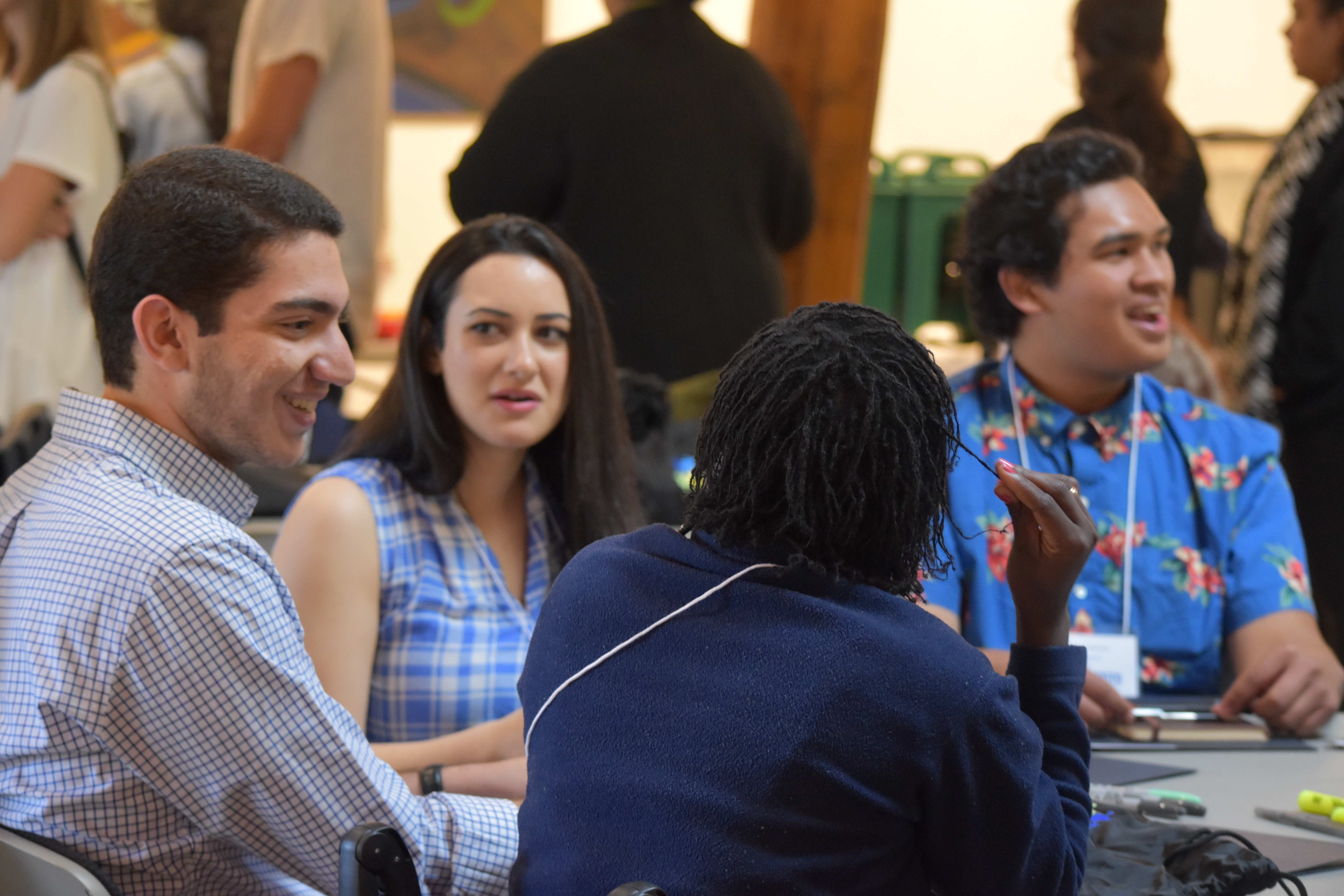 New Scholars sit talking together at a table at New Scholar Orientation.