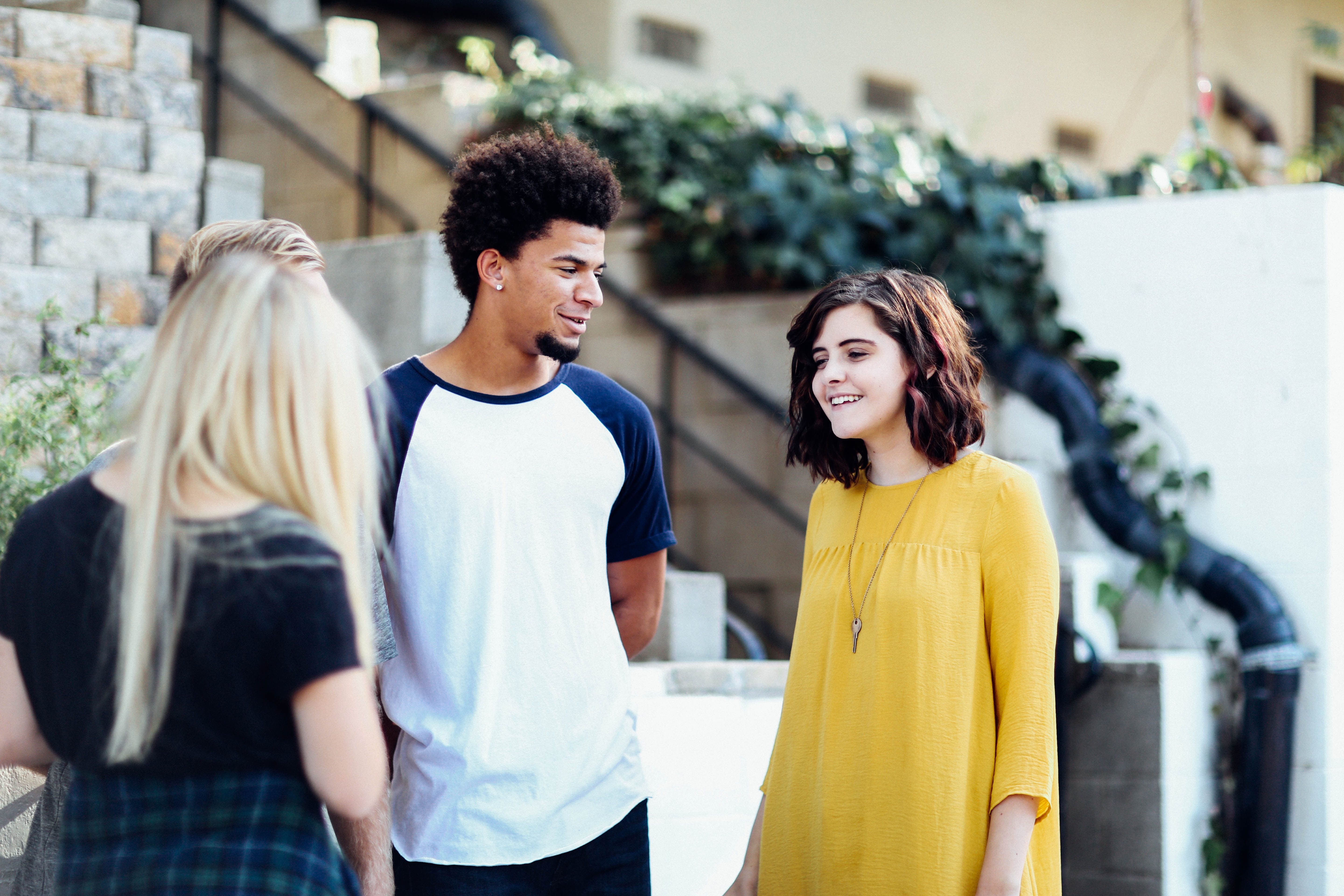 This photo is decorative. A group of students talking outside a building.