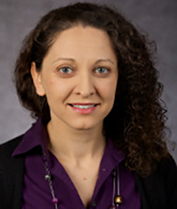 Photo of Olya Glantsman smiling and wearing a purple shirt. 