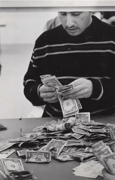 Student at registrar, counting out money