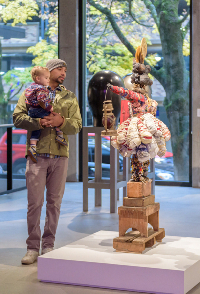 Father and son look at a sculpture