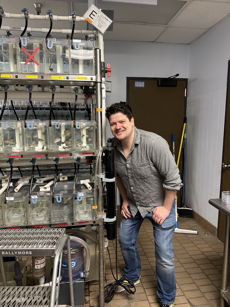 Pat standing by fish tanks