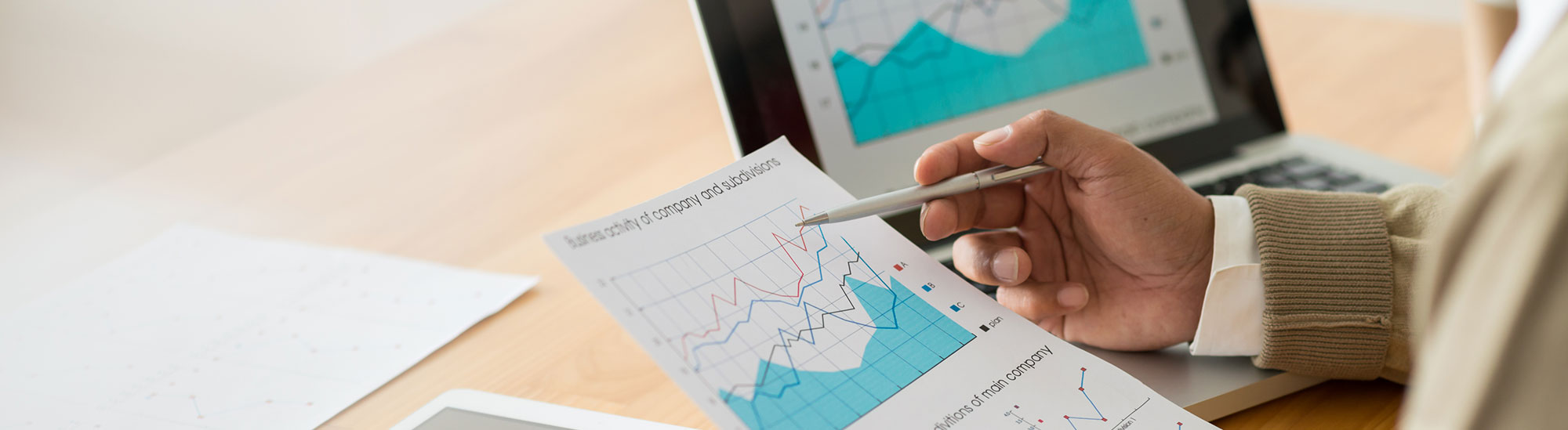 Man pointing at graphs with a pen