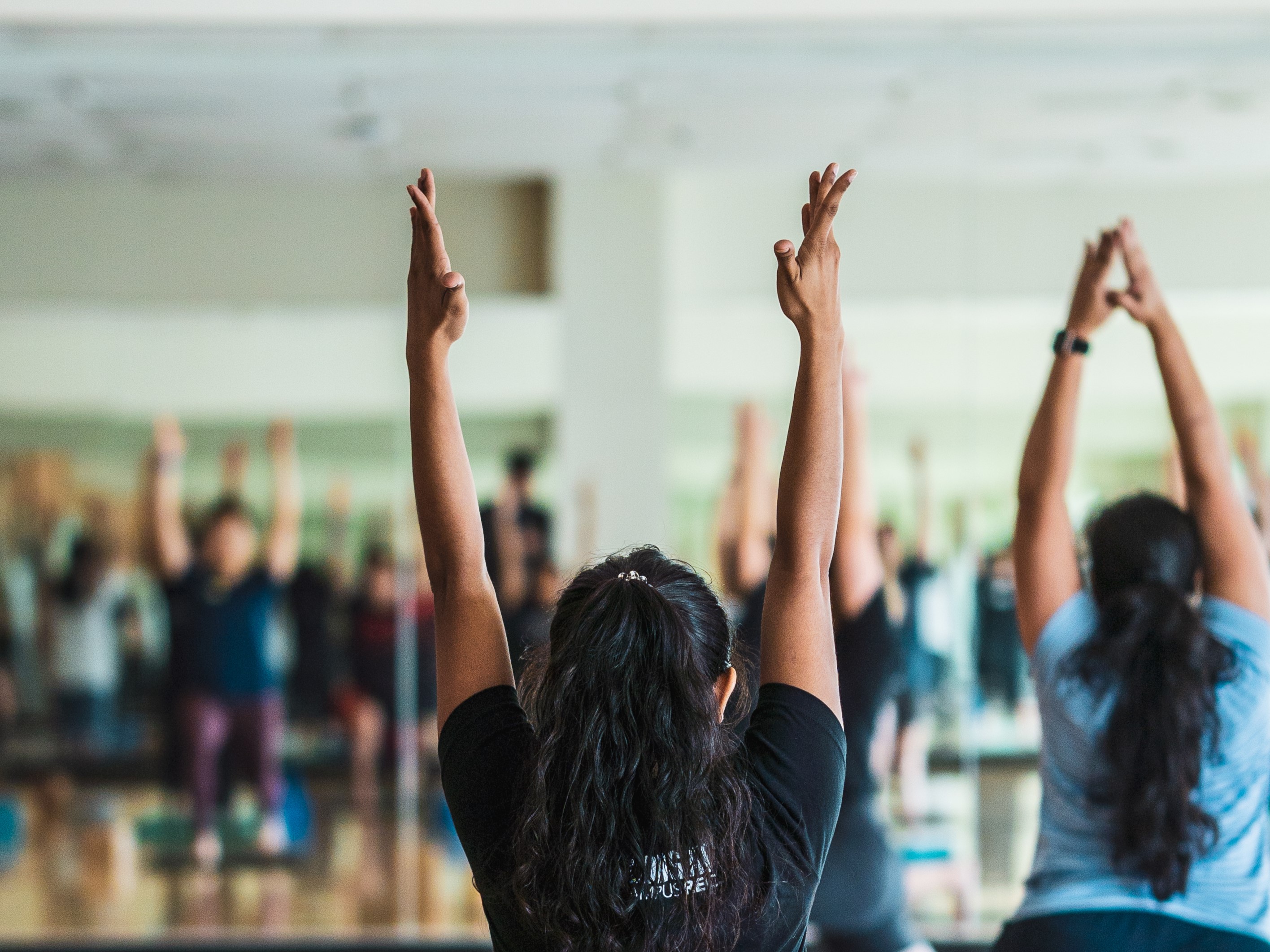 Close up of person stretching in a group fitness class