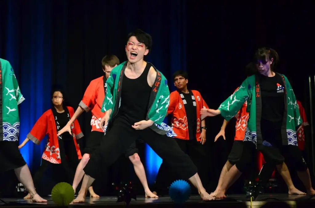 Students performing a dance on stage