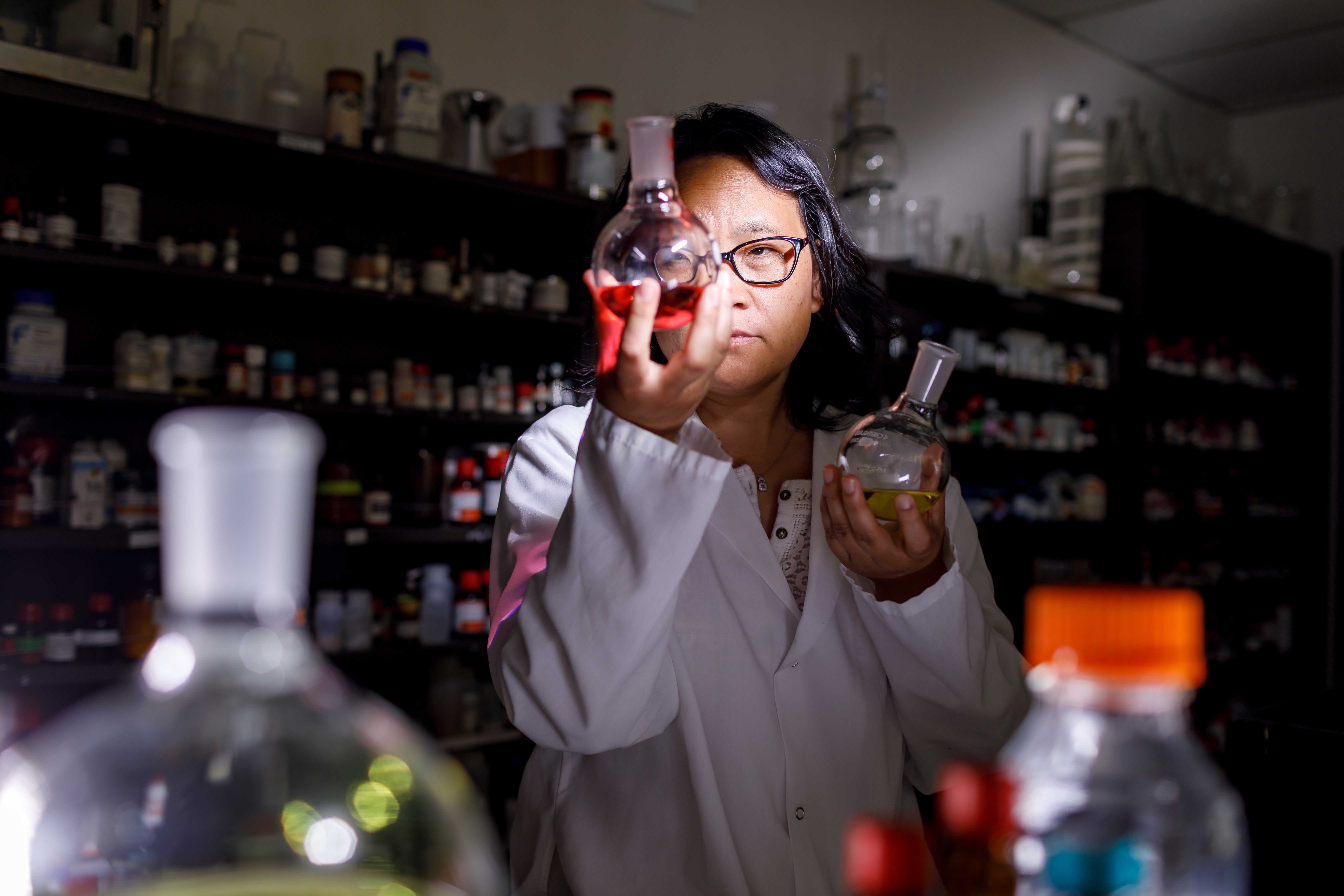 Professor looking at lab flask
